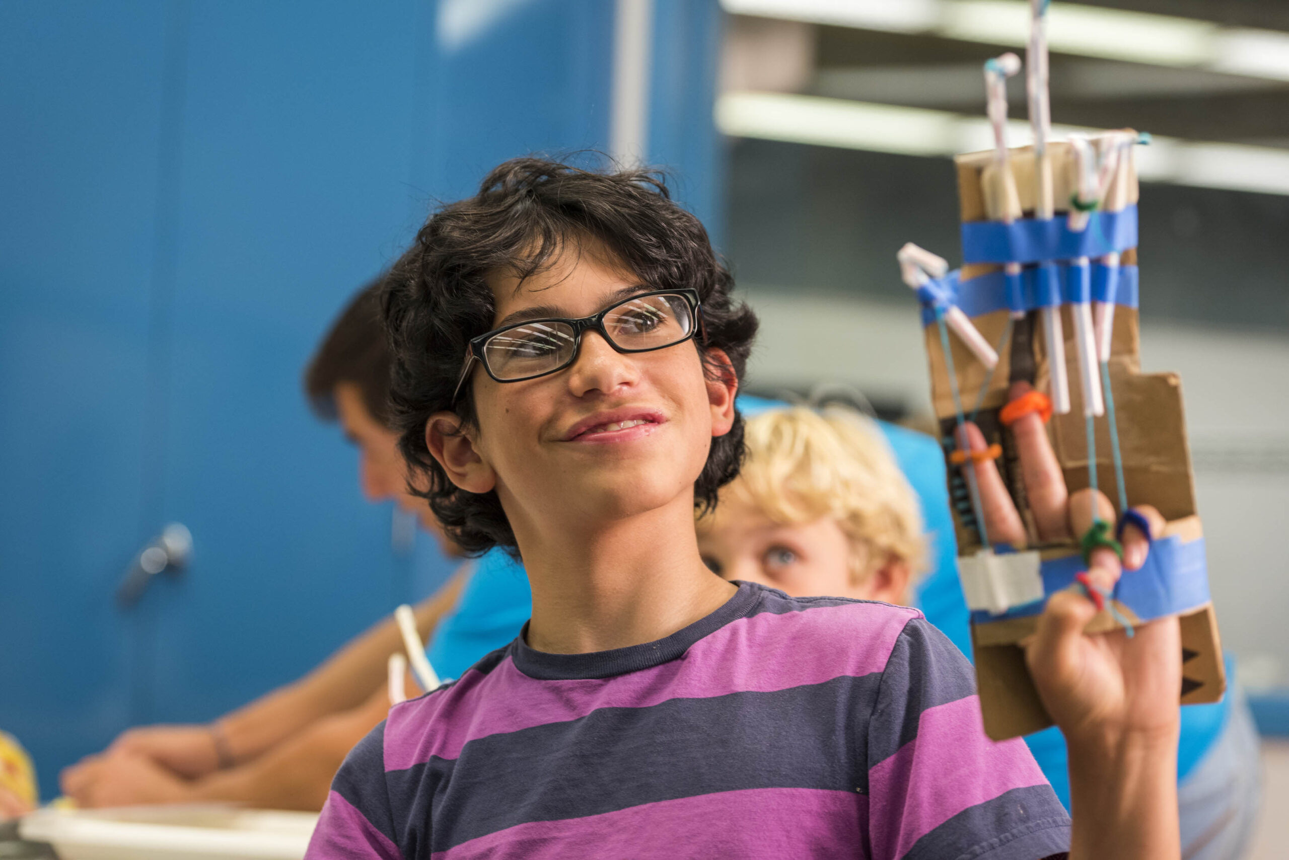 A student holding up his invention
