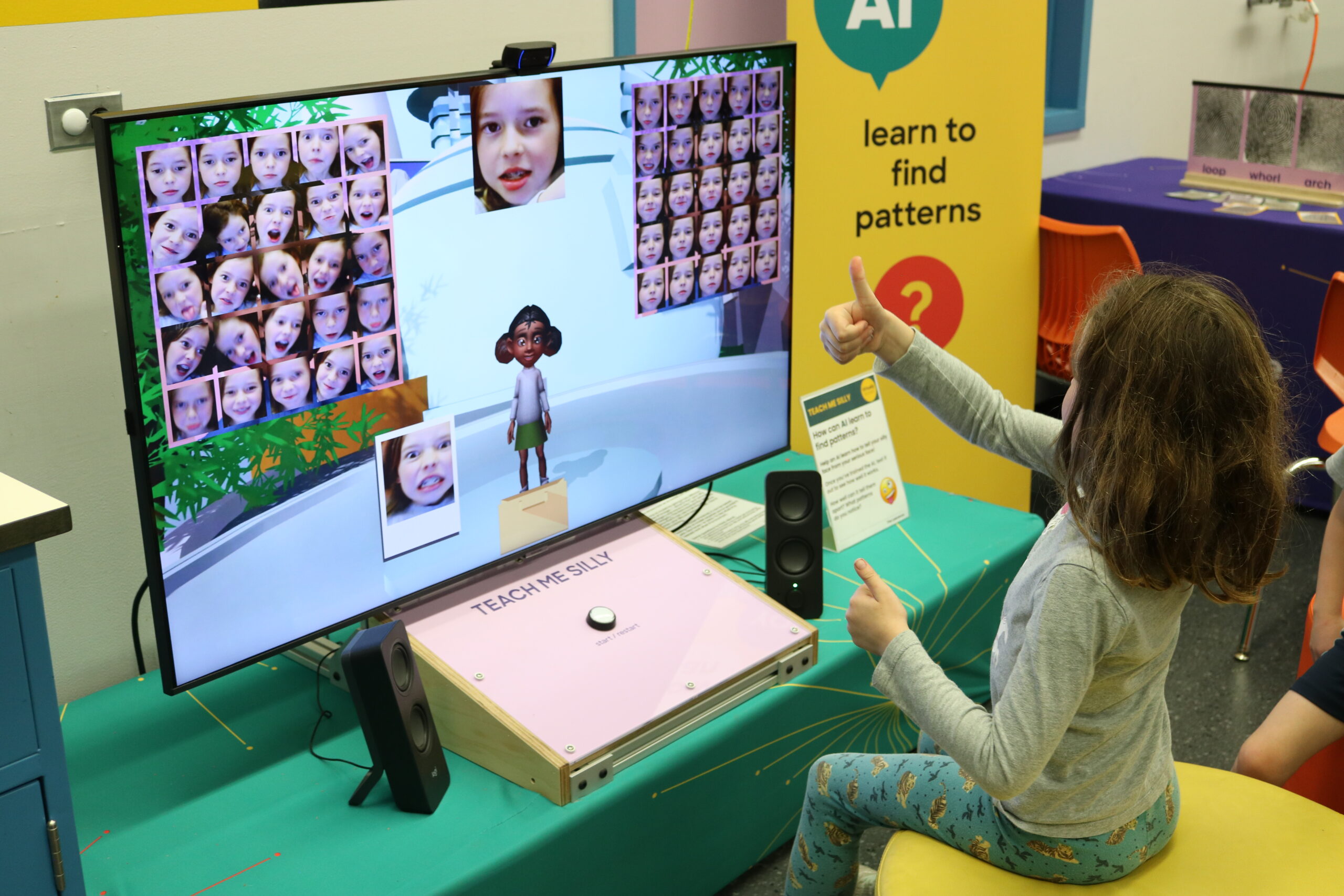A child explores the Virtually Human AI exhibit.
