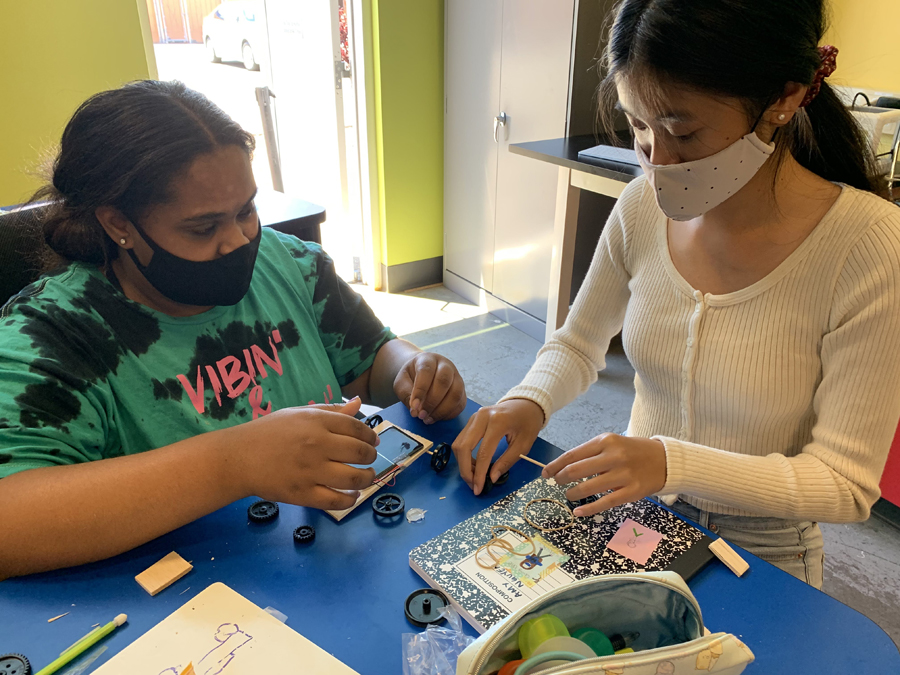 Two students are working on a solar project