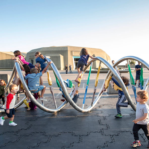 Children on the DNA Sculpture on the plaza at The Lawrence