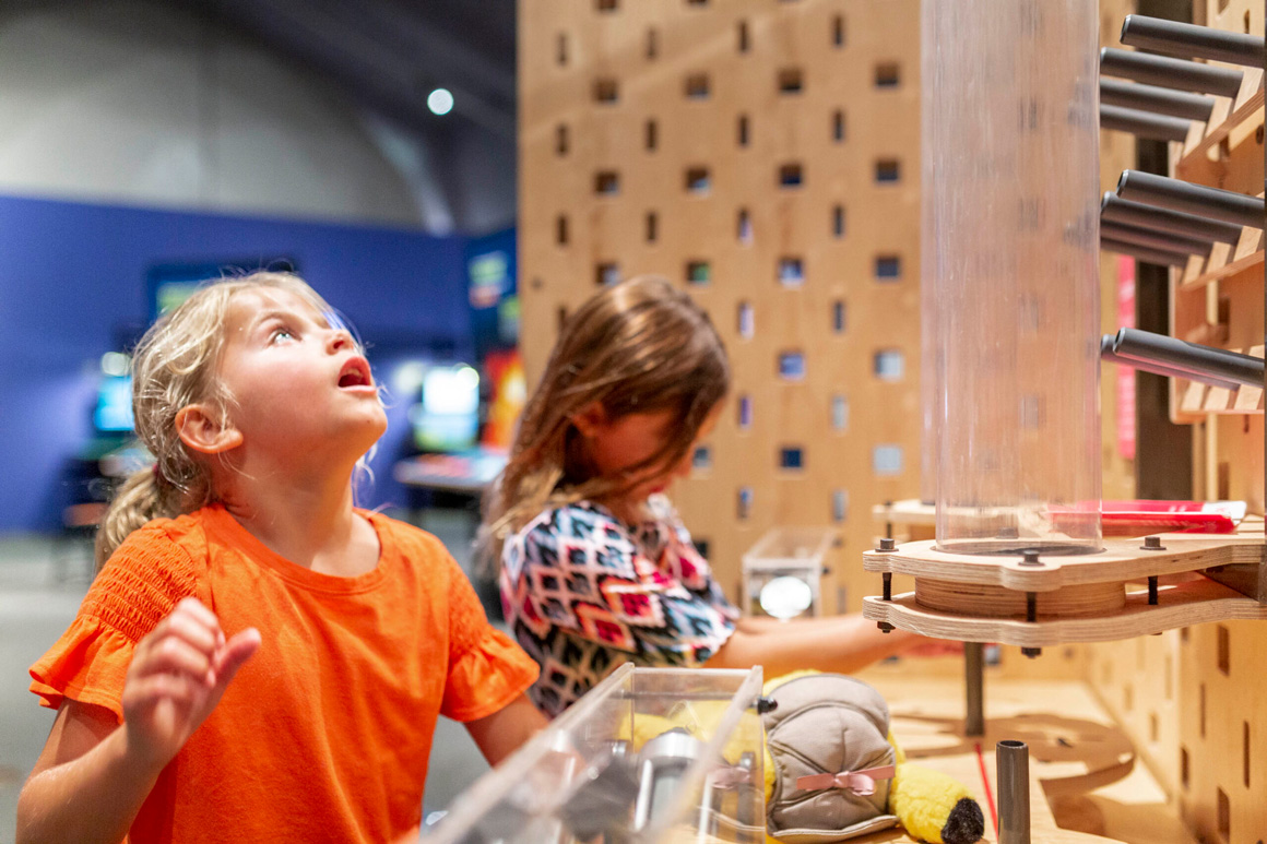 Two children exploring a science exhibit