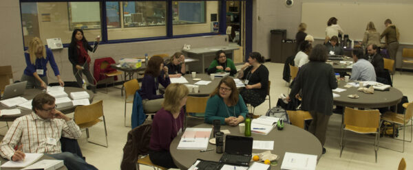 Teachers sitting at tables at The Lawrence during a workshop
