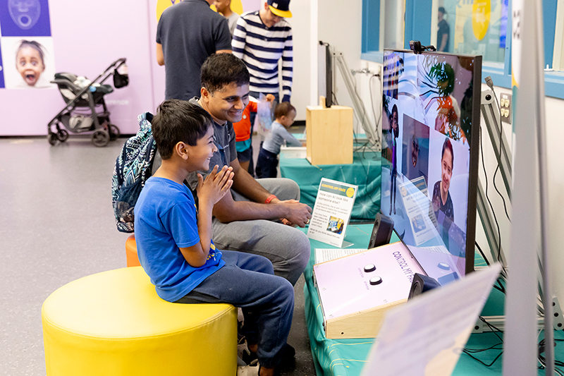 A child and parent interact with an activity in Virtually Human