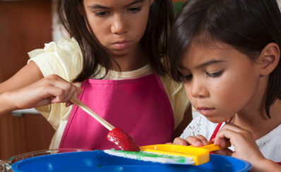 Two children learning about snotty noses in a science experiment