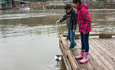 Two young people investigating a lake.