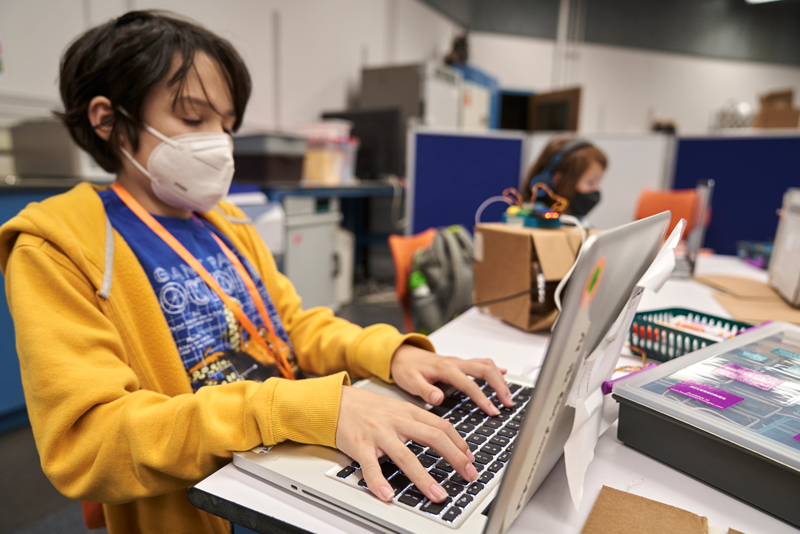 A student is using a laptop for a science project during a Teen Research Program