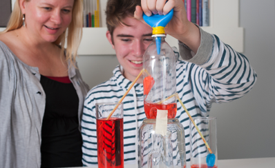 An adult and a young person create a science project to simulate a heart