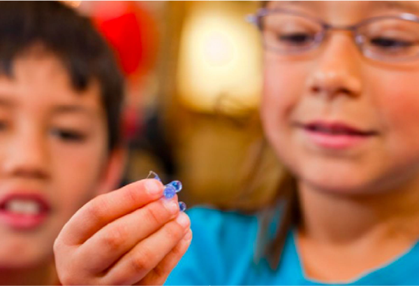 Two children are looking at delivery capsules