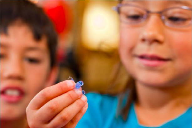 Two children are looking at delivery capsules