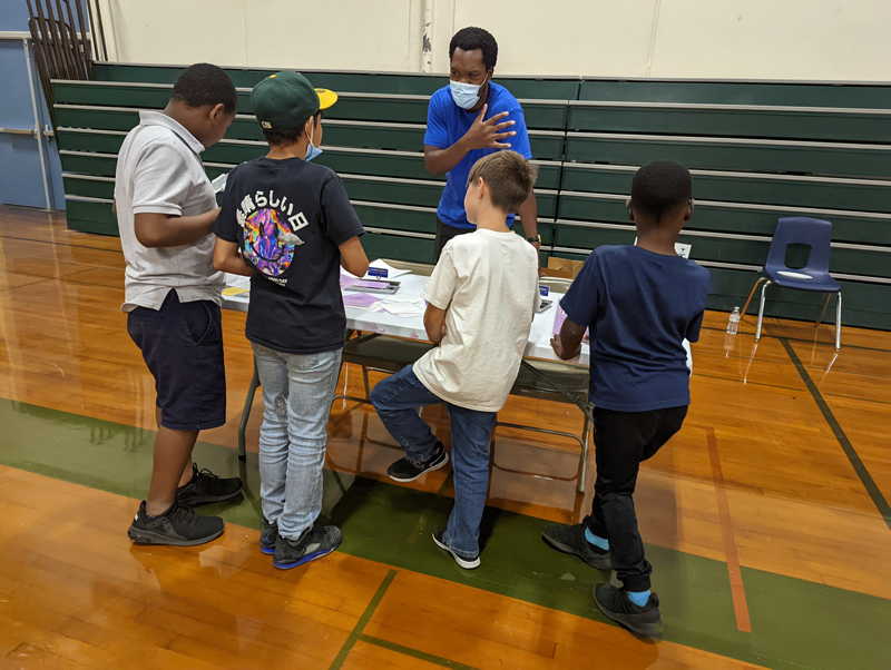 A Lawrence On-The-Go staff member is working with youth in the community
