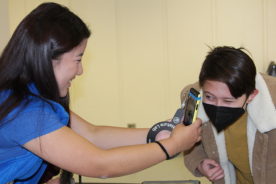 A volunteer is taking a photo with a phone
