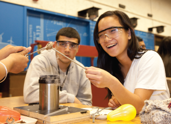 Two students conduct a science experiment