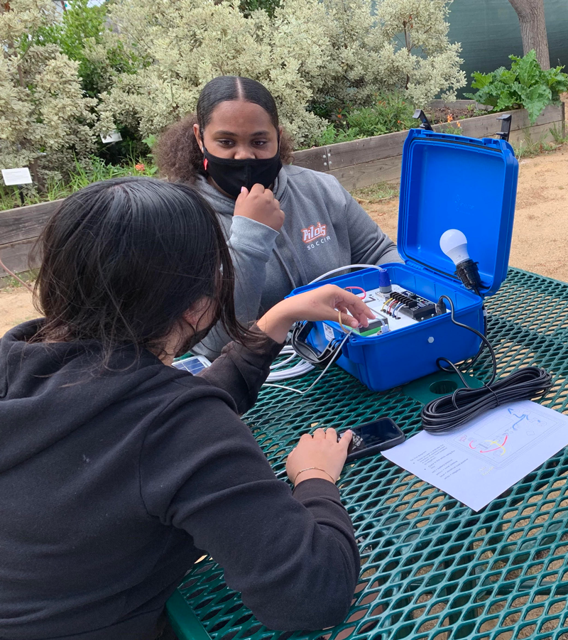Students from the YESS program are building solar suitcases.