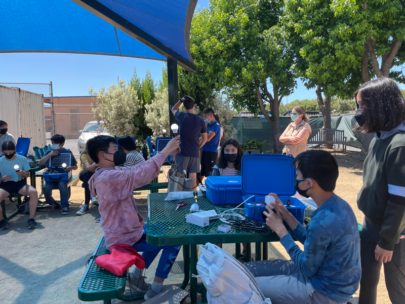 Students from the YESS program are building solar suitcases.